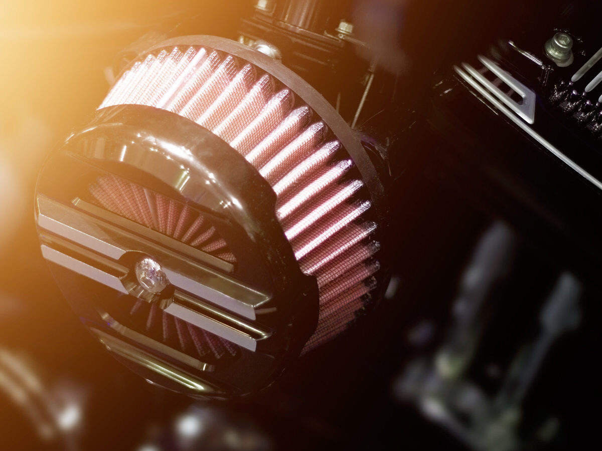 Close up air filter carburettor motorcycle on dark background